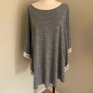 Grey cover-up top with crochet design around arm.